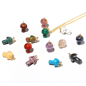 Mini mushroom natural stone pendants in various crystals with gold necklace on white background