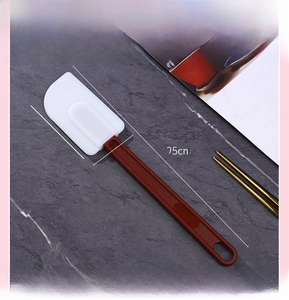 Macro detail of a 10 inch silicone spatula showing dimensions 25cm length and red handle