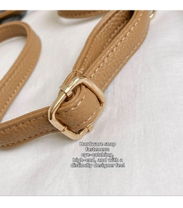 Close-up of brown litchi leather strap with premium gold metal square adjustment buckle