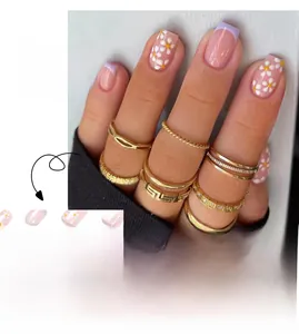 Detailed view of French purple tip press-on nails with white daisy floral designs
