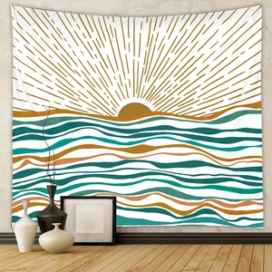 Close-up of bohemian tapestry with sun and wave pattern on minimalist grey wall