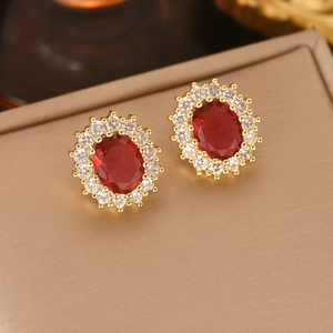 Elegant gold-tone halo earrings featuring oval red gemstones and clear zircon accents