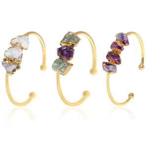 Adjustable gold-plated cuffs featuring natural amethyst and quartz crystal clusters