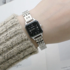 Elegant square quartz watch with silver steel strap and black dial for women on wrist