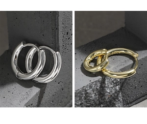 Detailed macro view of S925 sterling silver stamp on minimalist geometric hoop earrings