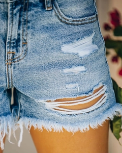 Gros plan sur un short en jean avec détails déchirés et bords effilochés bruts