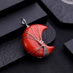 Detail of red moon stone pendant with silver wire-wrapped tree of life design
