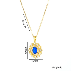 Golden titanium necklace with blue oval stone pendant surrounded by small pearls