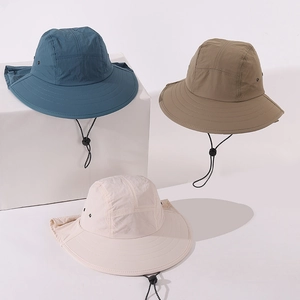 Detail view of kids sun hats in navy, khaki, and cream with neck protection and chin straps