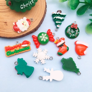 Detailed assortment of festive resin Christmas charms including Santa, trees and snowflakes