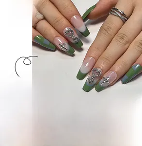 Detail of French blue-green checkered press-on nails with 3D cross and heart rhinestones