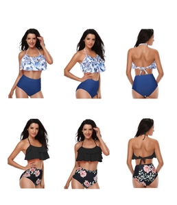 Detail view of high waisted bikini sets with ruffled tops and tropical floral prints