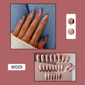 Detail view of pink almond nails with brown and white lines including model look