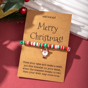 Christmas polymer clay bracelet with Santa pendant on kraft card in festive holiday setting
