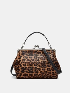 Detail of leopard print handbag with metal frame clasp and detachable black shoulder strap