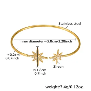 Vue détaillée du jonc en acier doré avec motif d'étoile serti de zircon brillant