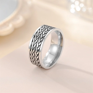 Macro detail of silver vintage titanium steel ring with textured wheat pattern engraving