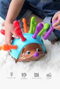 Detail of baby hedgehog toy showing motor skills training and color recognition icons