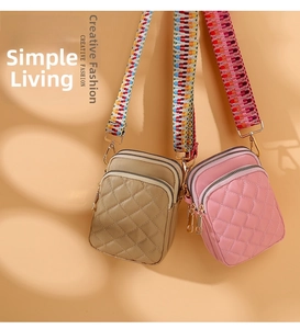 Detail of quilted nylon mobile phone bags with multi-layer zippers and woven straps