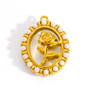 Detail of oval gold pendant featuring rose motif and white pearl border in studio lighting