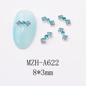 Detail showing 8x3mm light blue crystal bow nail charms with silver metal base