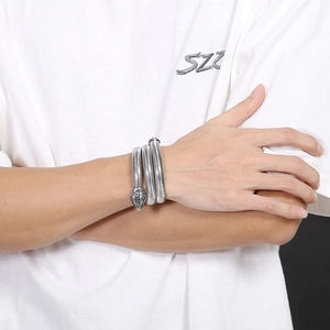 Macro detail of silver stainless steel snake wrap bracelet with textured scales and carving