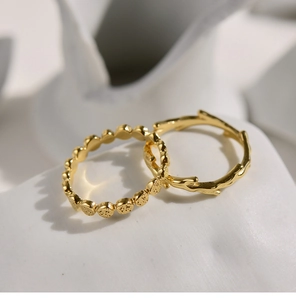 Macro detail of gold-plated honeycomb and organic branch rings on ceramic surface