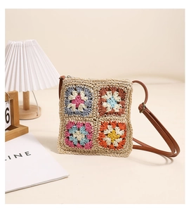 Close-up of handmade floral crochet crossbody bag with retro granny square texture