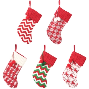 Knitted Christmas stockings with reindeer and snowflake patterns in red, white and green