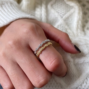 Set of two minimalist S925 sterling silver rings with bubble texture on model finger