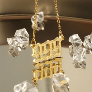 Golden 1991 lucky number necklace with matte finish on reflective mirror surface
