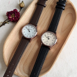Flat lay of vintage style quartz watches with leather straps and large numeric dial face