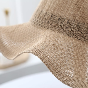 Elegant summer sun hat for women with knit hollow pattern and wavy brim in beige