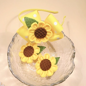 Three-piece sunflower hair accessory set with yellow polka dot bow headband and clips