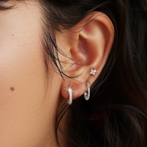 Close-up of S925 sterling silver hoop earrings set with zircon stones on an ear