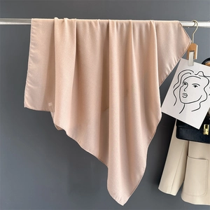 Close-up of soft beige cotton linen shawl showing natural drape and fine fabric texture