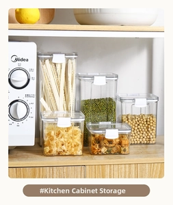 Close-up of 5-piece airtight kitchen storage containers with white locking lids on wood