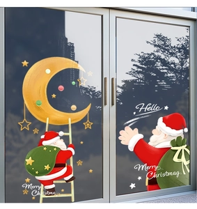 Detail of Santa Claus and golden moon static PVC stickers on glass doors for Christmas decor