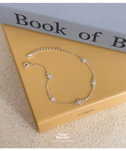Detailed shot of S925 sterling silver flower bracelet with small blossoms and lobster clasp