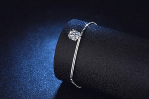 Macro detail of S925 silver bracelet featuring a brilliant moissanite and polished metal bar