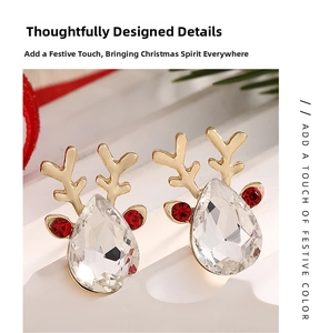 Macro view of gold reindeer stud earrings with crystal teardrop and festive details