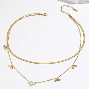 Detail of double-layer gold necklace with white shell heart pendant and lobster clasp