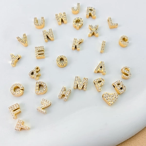 Micro paved zircon alphabet pendants in gold finish featuring A-Z letters and symbols