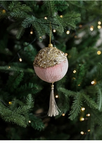 Detail of a pink velvet and gold glitter Christmas ball ornament with hanging tassel