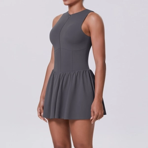 Dettaglio dell'abito da tennis grigio scuro con collo alto a zip e gonna con pieghe