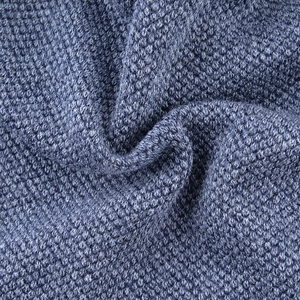 Detailed macro view of heavy knit fabric texture with navy and white blended yarn