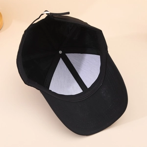 Detail view of adjustable strap and internal lining of black star baseball cap