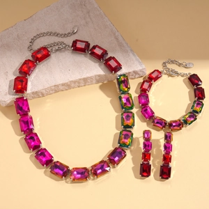 Detailed view of 3-piece jewelry set with rectangular gradient red crystals on silver base