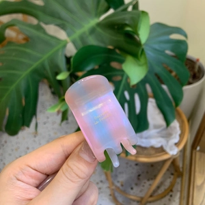 Pink and blue gradient translucent resin hair claw clip held in hand for high ponytail