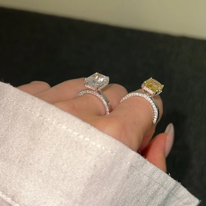 Close-up of S925 silver rings featuring rectangular white and yellow sparkling zircons